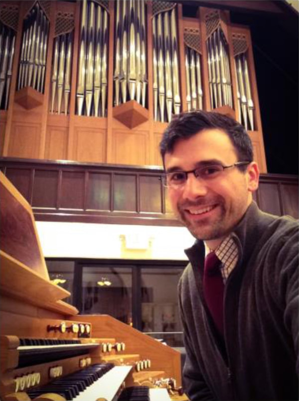 Dr. Russell Weismann sitting at the organ